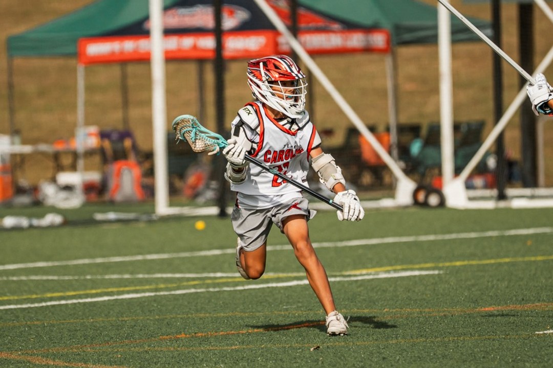Team Carolina Elite boys travel lacrosse player driving downfield at a Charlotte tournament